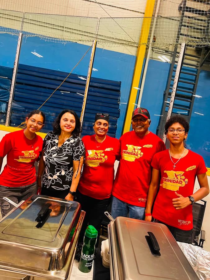 With volunteers serving at a Caribbean community celebration